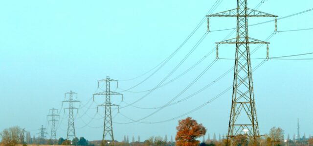 brown and black electric towers under white sky during daytime