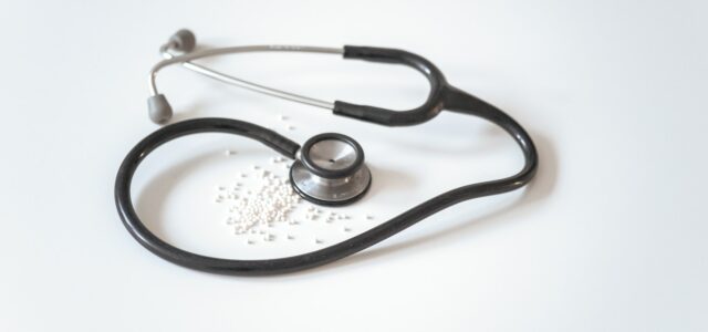 black and silver stethoscope on white surface