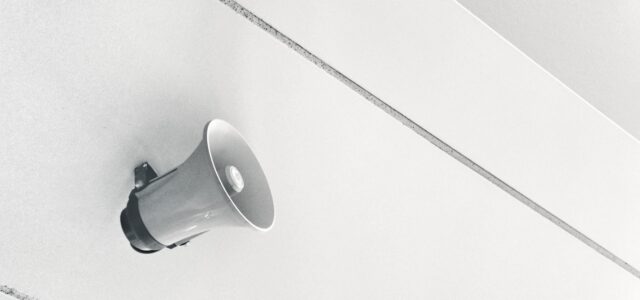 gray megaphone on white surface