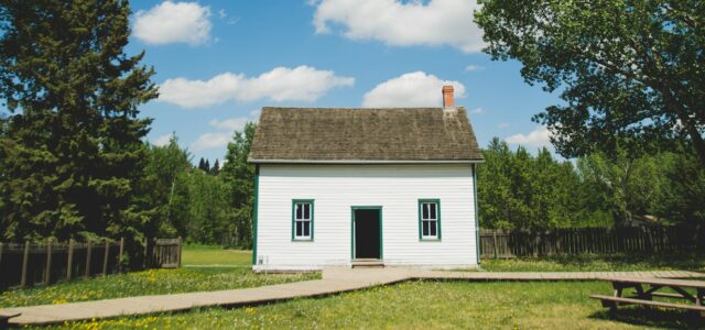 white wooden house between trees